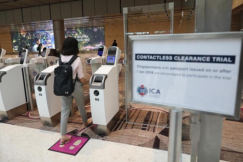 A traveller using the contactless clearance at Changi Airport.